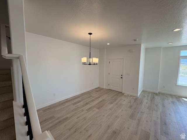 306 E 1480 N Unit 44, Salem, UT 84653 - unfurnished dining area with light wood-type flooring, a chandelier, stairs, a textured ceiling, and recessed lighting
