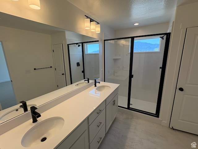 306 E 1480 N Unit 44, Salem, UT 84653 - bathroom featuring a textured ceiling, a shower stall, plenty of natural light, and double vanity