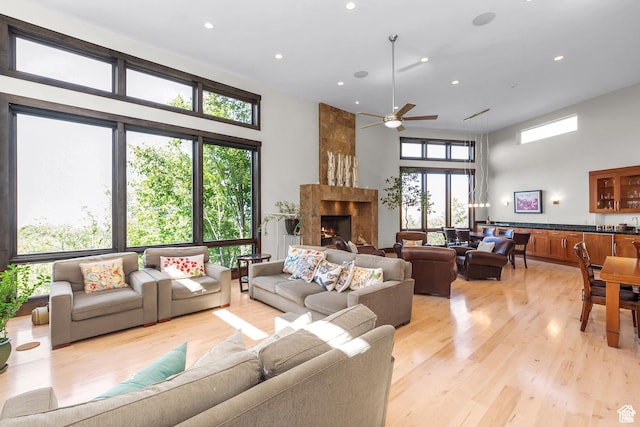 4127 E Mathews Way S, Salt Lake City, UT 84124 - living room with a towering ceiling, ceiling fan, a high end fireplace, light wood-style floors, and recessed lighting