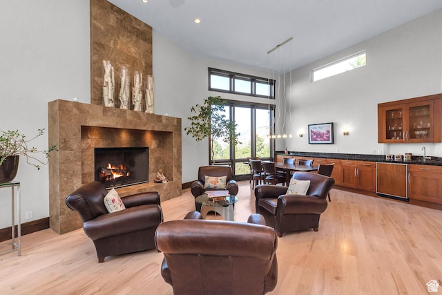 4127 E Mathews Way S, Salt Lake City, UT 84124 - living area with a high ceiling, light wood-style floors, a fireplace, plenty of natural light, and recessed lighting