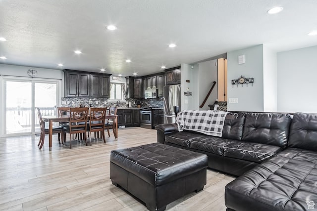 254 W 1600 N, Harrisville, UT 84404 - living room with recessed lighting, healthy amount of natural light, light wood-type flooring, and a textured ceiling