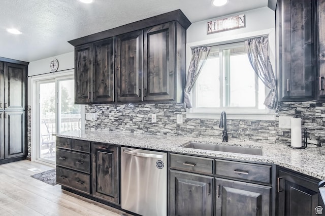 254 W 1600 N, Harrisville, UT 84404 - kitchen featuring dishwasher, light wood finished floors, tasteful backsplash, light stone counters, and a textured ceiling