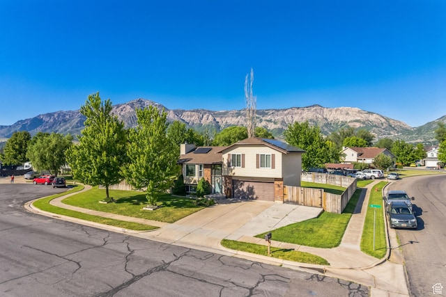 254 W 1600 N, Harrisville, UT 84404 - split level home featuring a mountain view, roof mounted solar panels, a garage, and driveway