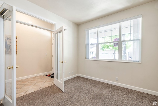 674 E Free Land Ave S, Midvale, UT 84047 - unfurnished bedroom featuring french doors, light colored carpet, and a wall unit AC
