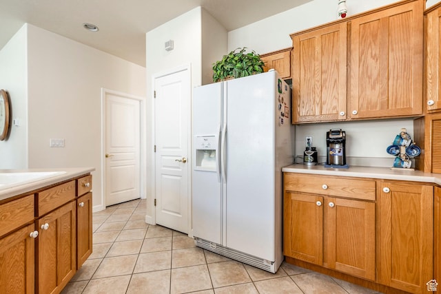 674 E Free Land Ave S, Midvale, UT 84047 - kitchen with white fridge with ice dispenser, light tile patterned floors, light countertops, and brown cabinets