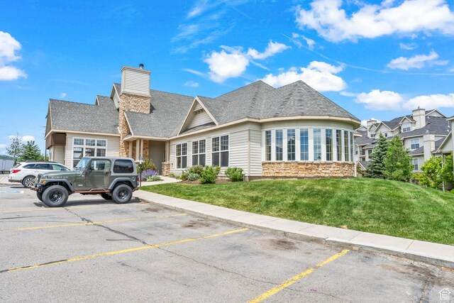 900 Bitner Rd Unit K25, Park City, UT 84098 - view of front of house featuring stone siding, uncovered parking, a front yard, and a chimney