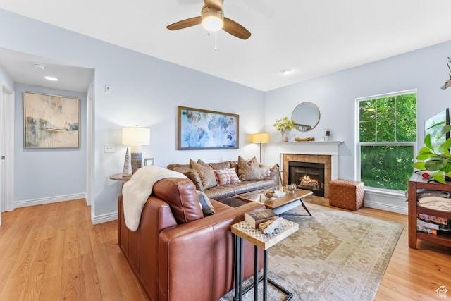 900 Bitner Rd Unit K25, Park City, UT 84098 - living area featuring light wood finished floors, a ceiling fan, and a tiled fireplace