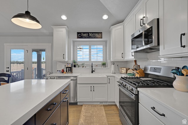 1792 W Norway Spruce Dr, Layton, UT 84041 - kitchen featuring stainless steel appliances, light countertops, white cabinetry, and recessed lighting