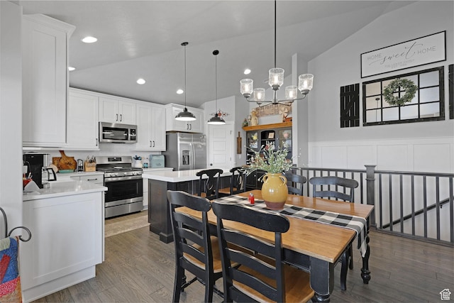 1792 W Norway Spruce Dr, Layton, UT 84041 - dining room featuring dark wood-style floors, recessed lighting, a chandelier, wainscoting, and vaulted ceiling