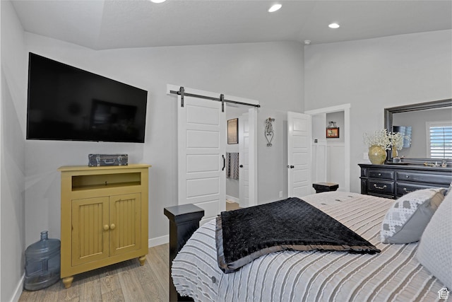 1792 W Norway Spruce Dr, Layton, UT 84041 - bedroom with a barn door, light wood-style floors, recessed lighting, and high vaulted ceiling