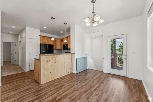 1535 W 80 S, Pleasant Grove, UT 84062 - kitchen with black appliances, wood finished floors, a chandelier, pendant lighting, and a peninsula