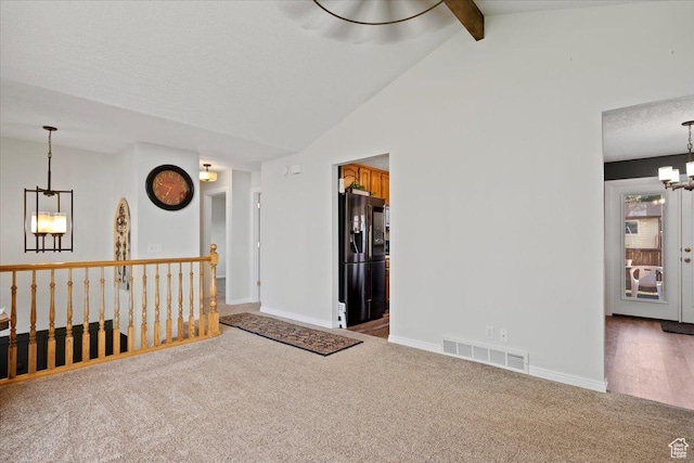 7351 W Zana Ln, Magna, UT 84044 - carpeted empty room featuring a chandelier, beam ceiling, and high vaulted ceiling