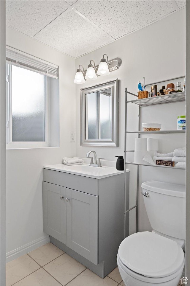 7351 W Zana Ln, Magna, UT 84044 - bathroom with vanity, a paneled ceiling, and marble look tile flooring