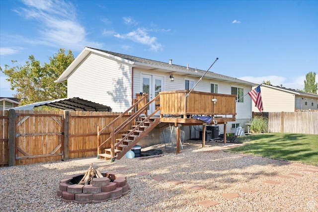 7351 W Zana Ln, Magna, UT 84044 - back of house with a fire pit, stairway, a fenced backyard, a deck, and french doors
