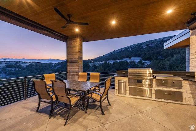 1545 N Red Castle Cir, Heber City, UT 84032 - view of patio / terrace with a mountain view, exterior kitchen, ceiling fan, and outdoor dining space