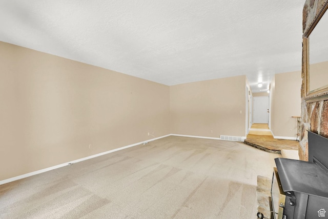 293 E 5450 S Unit 19, Washington Terrace, UT 84405 - unfurnished living room with a fireplace, light colored carpet, and a textured ceiling