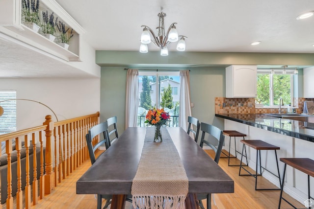 1696 N 2640 W, Lehi, UT 84043 - dining space featuring light wood finished floors, a chandelier, recessed lighting, and healthy amount of natural light
