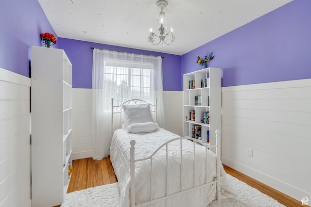 1696 N 2640 W, Lehi, UT 84043 - bedroom with a chandelier, wood finished floors, and a wainscoted wall