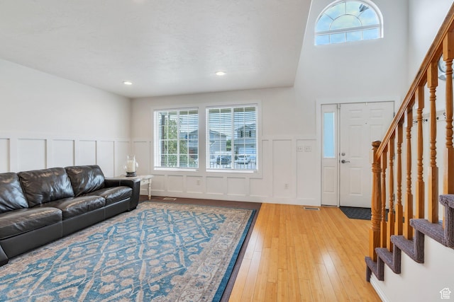 1696 N 2640 W, Lehi, UT 84043 - living room featuring stairs, a decorative wall, light wood finished floors, a wainscoted wall, and recessed lighting