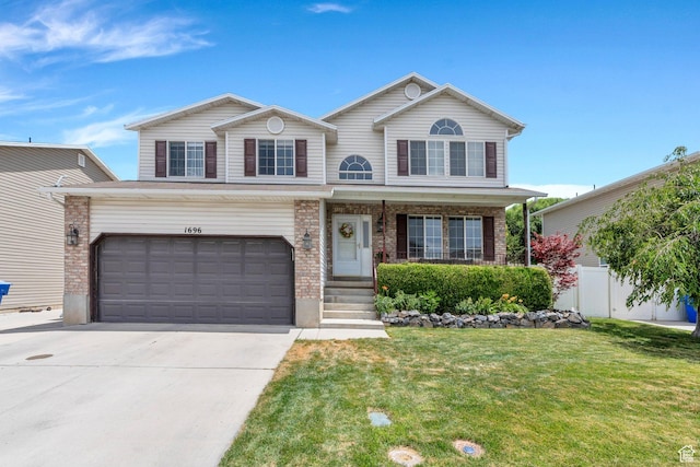 1696 N 2640 W, Lehi, UT 84043 - view of front facade with driveway, brick siding, covered porch, and a garage