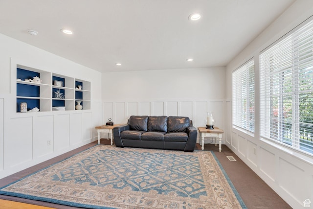 1696 N 2640 W, Lehi, UT 84043 - living room featuring a decorative wall, dark colored carpet, recessed lighting, and a wainscoted wall