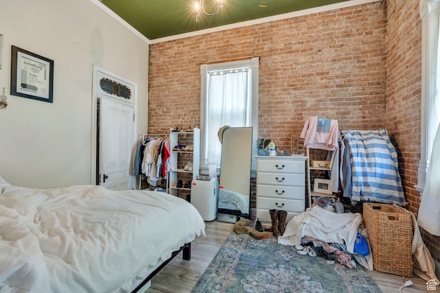 442 N 100 E, Provo, UT 84606 - bedroom with wood finished floors, crown molding, and brick wall