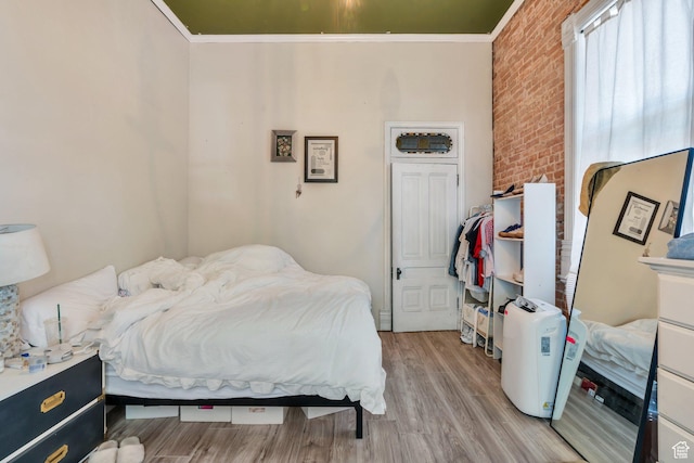 442 N 100 E, Provo, UT 84606 - bedroom featuring brick wall, light wood finished floors, and crown molding