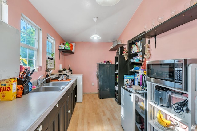 442 N 100 E, Provo, UT 84606 - kitchen with stainless steel microwave, light wood-style flooring, light countertops, and washer / dryer