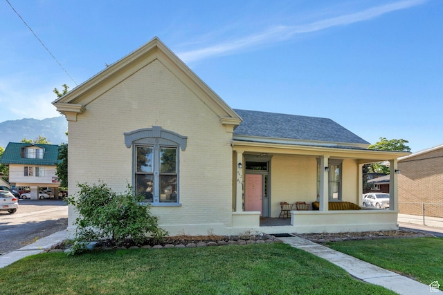 442 N 100 E, Provo, UT 84606 - view of front of property with brick siding, a porch, a front lawn, and roof with shingles