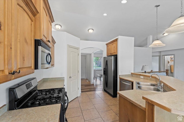 1827 E 1530 S, Spanish Fork, UT 84660 - kitchen featuring stainless steel appliances, arched walkways, light countertops, hanging light fixtures, and recessed lighting