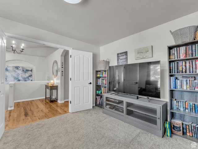 4587 W Flintlock Way, Herriman, UT 84096 - living area featuring carpet, a chandelier, and arched walkways