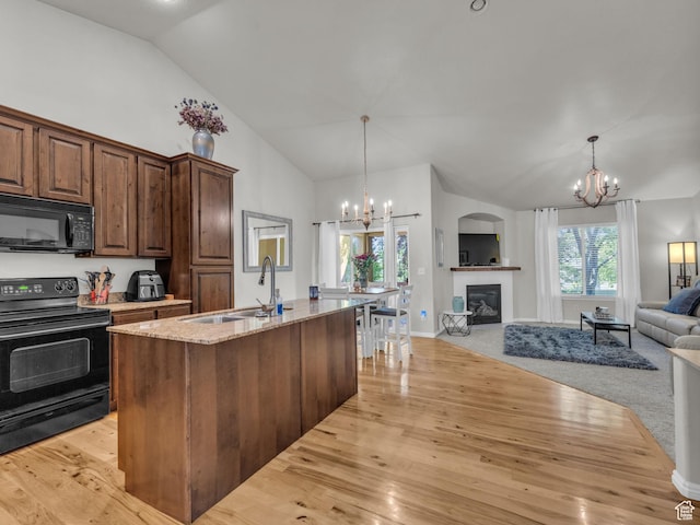 4587 W Flintlock Way, Herriman, UT 84096 - kitchen with black appliances, a chandelier, open floor plan, light wood-style floors, and high vaulted ceiling