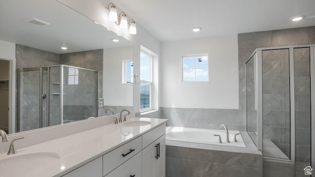 903 W Fallow Dr Unit 212, Saratoga Springs, UT 84045 - bathroom with double vanity, a stall shower, a garden tub, and recessed lighting