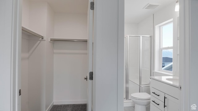 903 W Fallow Dr Unit 212, Saratoga Springs, UT 84045 - bathroom featuring a stall shower, a walk in closet, and vanity
