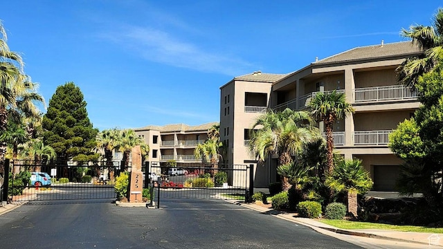 225 N Country Ln Unit 5, St George, UT 84770 - view of asphalt road featuring a gate, a gated entry, and curbs