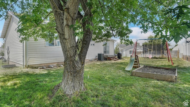 285 W 90 N, Clearfield, UT 84015 - view of yard featuring entry steps, a vegetable garden, a playground, and a trampoline