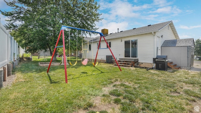 285 W 90 N, Clearfield, UT 84015 - rear view of property with a playground, a fenced backyard, and a storage unit