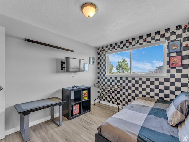 4273 W Annapolis Dr S, West Valley City, UT 84120 - bedroom featuring a textured ceiling, wood finished floors, and an accent wall