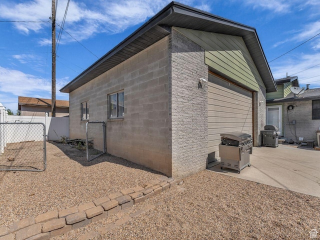 4273 W Annapolis Dr S, West Valley City, UT 84120 - view of home's exterior featuring a garage and a patio area