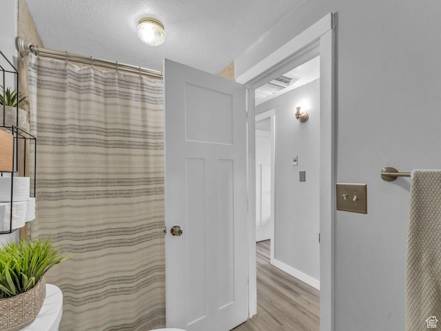 4273 W Annapolis Dr S, West Valley City, UT 84120 - full bathroom featuring wood finished floors and curtained shower