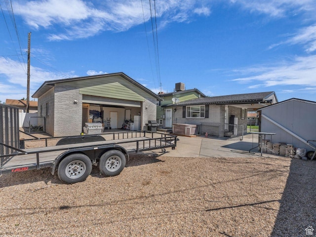 4273 W Annapolis Dr S, West Valley City, UT 84120 - rear view of property featuring brick siding and a patio area