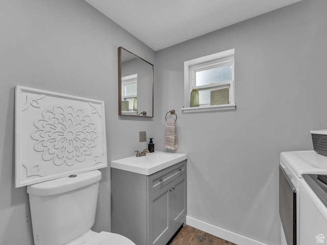 4273 W Annapolis Dr S, West Valley City, UT 84120 - bathroom with washer and clothes dryer, vanity, and wood finished floors