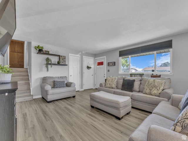 4273 W Annapolis Dr S, West Valley City, UT 84120 - living room featuring light wood-style flooring and stairway