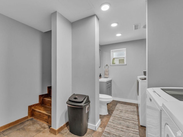 4273 W Annapolis Dr S, West Valley City, UT 84120 - bathroom featuring separate washer and dryer, vanity, and recessed lighting