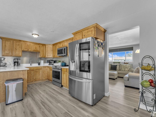 4273 W Annapolis Dr S, West Valley City, UT 84120 - kitchen with stainless steel appliances, light wood finished floors, light countertops, and a textured ceiling