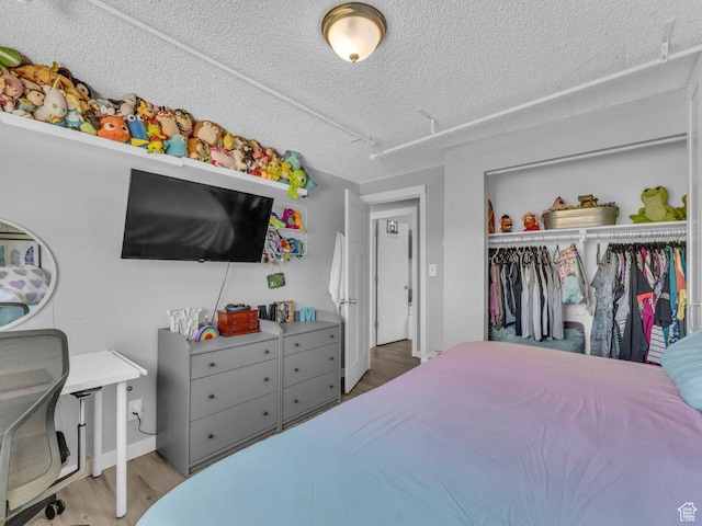 4273 W Annapolis Dr S, West Valley City, UT 84120 - bedroom with wood finished floors, a closet, and a textured ceiling