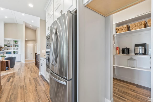 1155 S Eagle Nest Dr, Woodland Hills, UT 84653 - kitchen with stainless steel appliances, white cabinetry, light wood-style flooring, recessed lighting, and open floor plan