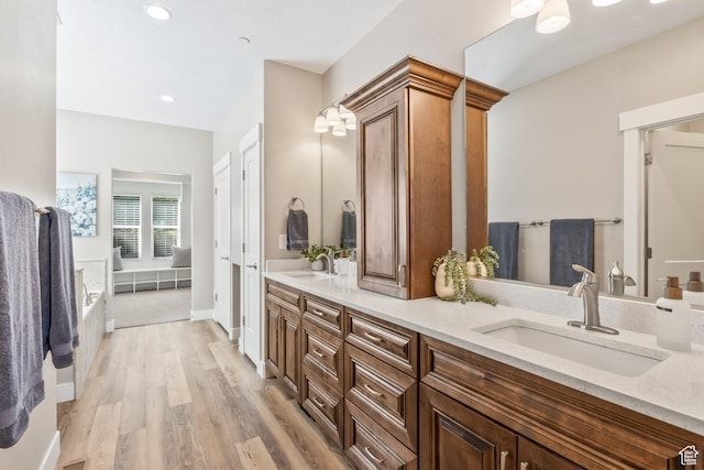1155 S Eagle Nest Dr, Woodland Hills, UT 84653 - bathroom featuring double vanity, wood finished floors, a tub, and recessed lighting