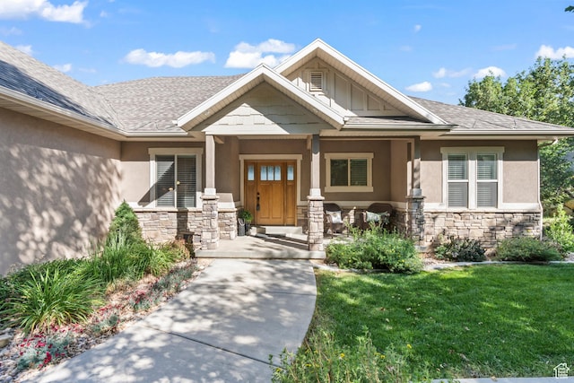 1155 S Eagle Nest Dr, Woodland Hills, UT 84653 - view of exterior entry with stucco siding, stone siding, and a yard