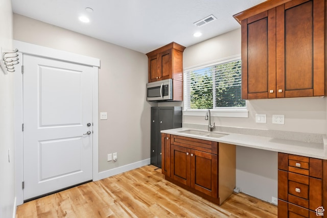 1155 S Eagle Nest Dr, Woodland Hills, UT 84653 - kitchen with stainless steel microwave, light wood-type flooring, light countertops, brown cabinets, and recessed lighting